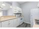 Functional kitchen equipped with white appliances and a breakfast bar overlooking the living area at 165 N Pearl Lake Cswy # 202, Altamonte Springs, FL 32714