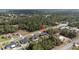 An aerial perspective reveals the property in a wooded setting, surrounded by other homes and streets at 16958 Sw 20Th Ct, Ocala, FL 34473