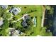 Aerial view of the property with a boat dock, manicured lawn, and large swimming pool at 17201 Magnolia Island Blvd, Clermont, FL 34711