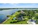 Expansive waterfront estate featuring lush lawns, private pool, and docks along the serene lake at 17201 Magnolia Island Blvd, Clermont, FL 34711