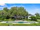 Expansive backyard features an in-ground pool, lounge furniture, and a serene water view at 17201 Magnolia Island Blvd, Clermont, FL 34711