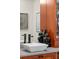 Bathroom with modern fixtures, vessel sink, stone countertop and wood cabinets at 17201 Magnolia Island Blvd, Clermont, FL 34711