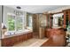 Full bathroom featuring a soaking tub, shower, and wood cabinets at 17201 Magnolia Island Blvd, Clermont, FL 34711