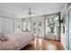Bright bedroom with french doors, wood floors and ceiling fan at 17201 Magnolia Island Blvd, Clermont, FL 34711