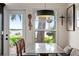 Cozy breakfast nook with glass table and serene waterfront view at 17201 Magnolia Island Blvd, Clermont, FL 34711