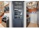 Butler pantry with glass cabinet, lighting, and stone accent wall at 17201 Magnolia Island Blvd, Clermont, FL 34711