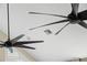 View up to the ceiling featuring two large, modern, black ceiling fans at 17201 Magnolia Island Blvd, Clermont, FL 34711