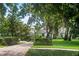 Beautiful landscaped front yard and brick driveway leading to an elegant home at 17201 Magnolia Island Blvd, Clermont, FL 34711