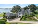 Stunning lakeside home features a brick driveway, lush landscaping, and a connecting garage at 17201 Magnolia Island Blvd, Clermont, FL 34711