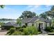 Elegant home exterior with lush landscaping and a tranquil lake backdrop at 17201 Magnolia Island Blvd, Clermont, FL 34711