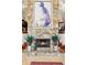 Stone fireplace featuring an abstract painting and hearth with potted plants at 17201 Magnolia Island Blvd, Clermont, FL 34711