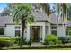 Inviting home entrance features a dark wood door, manicured bushes, and stone pathway at 17201 Magnolia Island Blvd, Clermont, FL 34711