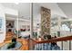 Bright living room with a stone accent wall, lots of windows, and open floor plan at 17201 Magnolia Island Blvd, Clermont, FL 34711