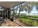 A screened-in patio offers views of lush landscaping and the tranquil water, perfect for relaxation and enjoying nature at 17201 Magnolia Island Blvd, Clermont, FL 34711