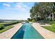 Spacious in-ground pool is surrounded by lush landscaping and offers breathtaking water views at 17201 Magnolia Island Blvd, Clermont, FL 34711