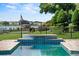 Custom pool includes a built-in spa, blue tile details, and a serene water feature at 17201 Magnolia Island Blvd, Clermont, FL 34711