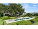 An inviting pool and spa area set against a backdrop of mature trees and water views promises ultimate relaxation at 17201 Magnolia Island Blvd, Clermont, FL 34711