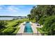 Beautiful in-ground pool overlooking the lake, complete with lounge chairs and manicured lawn at 17201 Magnolia Island Blvd, Clermont, FL 34711