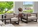 Cozy sitting area with gramophone, matching armchairs, and views of the lake at 17201 Magnolia Island Blvd, Clermont, FL 34711