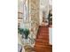 Wooden staircase with stone accent wall and potted plants at 17201 Magnolia Island Blvd, Clermont, FL 34711