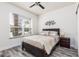 Cozy bedroom featuring a large window for natural light and a comfortable bed at 17403 Placidity Ave, Clermont, FL 34714