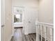 Hallway view leading into a well-lit bedroom with a ceiling fan and a balcony at 17403 Placidity Ave, Clermont, FL 34714