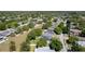 An aerial view of a residential neighborhood featuring tree-lined streets and well-maintained homes at 1744 Setting Sun Loop, Casselberry, FL 32707