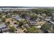 An aerial view of a neighborhood surrounded by trees, with a lake view at 17529 Eve Dr, Montverde, FL 34756