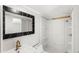 Bathroom featuring a sleek white vanity, a modern mirror, and a shower with a white surround at 17529 Eve Dr, Montverde, FL 34756