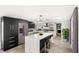 Modern kitchen featuring an island, stainless steel appliances, and stylish backsplash at 17529 Eve Dr, Montverde, FL 34756