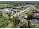 An aerial view of a residential neighborhood with well-maintained homes, lush landscaping, and paved streets at 1938 Filly Trl, Oviedo, FL 32765