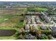 Drone shot showcasing homes with pools bordering a pond and undeveloped land at 1938 Filly Trl, Oviedo, FL 32765