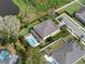 An aerial view highlights a home with a private pool, lush lawn, and thoughtfully designed landscaping at 1938 Filly Trl, Oviedo, FL 32765