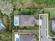 Aerial view shows a home with a sparkling pool and well-manicured lawn within a fenced yard at 1938 Filly Trl, Oviedo, FL 32765