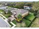 Aerial view of house showing palm trees, well-manicured lawn and landscaping, and a fully fenced yard at 1938 Filly Trl, Oviedo, FL 32765