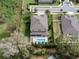 A captivating aerial perspective showcases a beautiful home with a pool, manicured lawn, and mature landscaping at 1938 Filly Trl, Oviedo, FL 32765