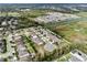 An aerial view of a neighborhood with community ponds reveals the layout and surrounding area at 1938 Filly Trl, Oviedo, FL 32765
