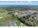 Beautiful aerial view of a residential neighborhood with lush greenery and a tranquil pond at 1938 Filly Trl, Oviedo, FL 32765