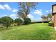 Lush backyard features a meticulously maintained lawn, manicured hedges, and decorative trees at 1938 Filly Trl, Oviedo, FL 32765