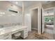 Bright bathroom featuring a vanity area, modern shower and a walk-in closet at 1938 Filly Trl, Oviedo, FL 32765