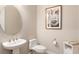 Powder room featuring a modern pedestal sink, toilet and decorative art at 1938 Filly Trl, Oviedo, FL 32765