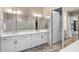 Bathroom featuring a double vanity and a door leading to a walk-in closet at 1938 Filly Trl, Oviedo, FL 32765
