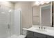 Bathroom featuring gray cabinets, white countertops and a glass-enclosed shower at 1938 Filly Trl, Oviedo, FL 32765