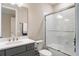 Modern bathroom features a sleek vanity, subway tile shower, and glass door enclosure at 1938 Filly Trl, Oviedo, FL 32765