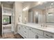 Bathroom with a large vanity, double sinks, and a door leading to the bedroom at 1938 Filly Trl, Oviedo, FL 32765