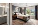 Bedroom with a dark accent wall, ensuite bathroom, and a window with a view at 1938 Filly Trl, Oviedo, FL 32765