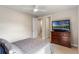 Bedroom featuring a queen bed, ceiling fan and a dresser with a TV at 1938 Filly Trl, Oviedo, FL 32765