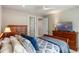 Bedroom featuring a sleigh bed with a blue comforter and wood dressers with a TV at 1938 Filly Trl, Oviedo, FL 32765