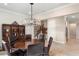 Elegant dining room with a dark wood table, seating for six, and a stylish light fixture at 1938 Filly Trl, Oviedo, FL 32765