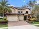Stunning two-story home with a three-car garage, beautiful landscaping, and a paver driveway at 1938 Filly Trl, Oviedo, FL 32765